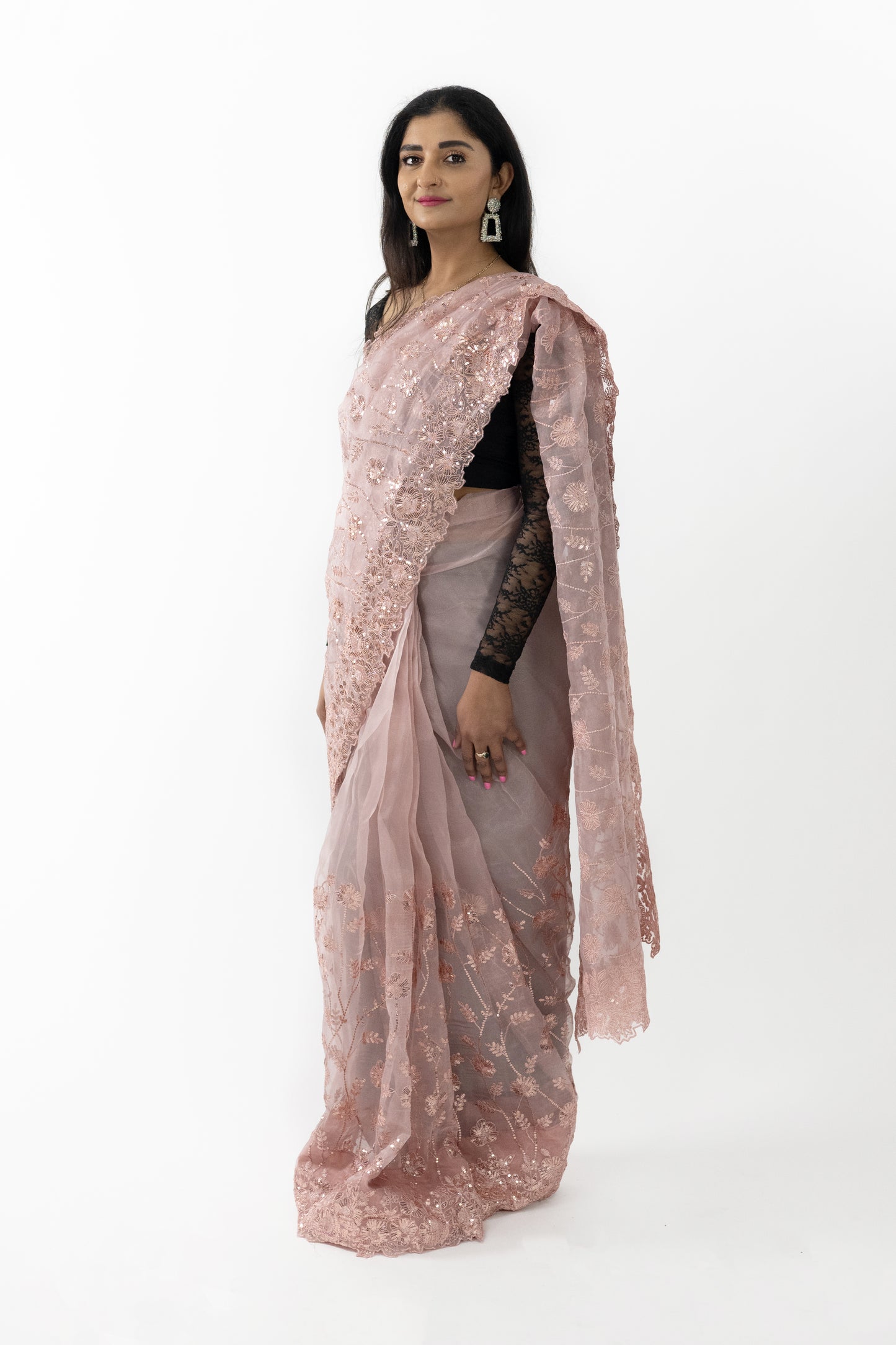 A close-up shot highlighting the intricate detailing on the ready-to-wear peach organza saree in Australia. The meticulous patterns showcase fine artistry, adding a touch of sophistication. The soft and lightweight fabric drapes beautifully, making it a stunning choice for any elegant event.