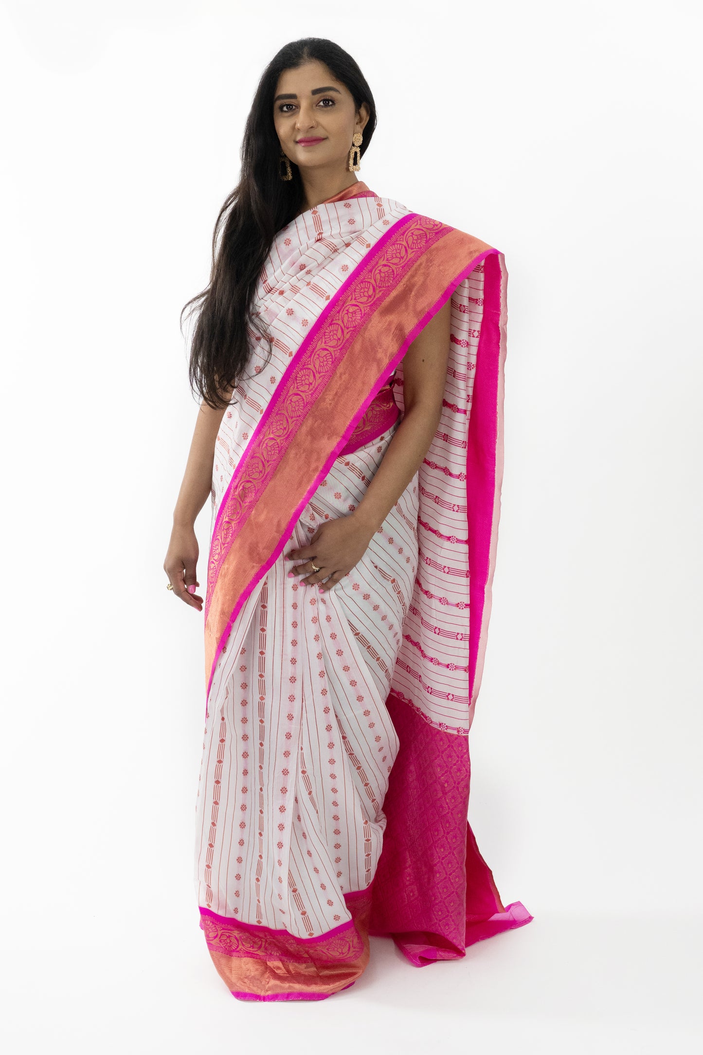 The image captures a person showcasing the beautiful drape of the ready-to-wear white Banarasi silk saree in Australia. The saree’s intricate pink detailing and luxurious silk fabric create a graceful and sophisticated appearance. Ideal for weddings, festivals, and special celebrations, this saree exudes timeless beauty and elegance.