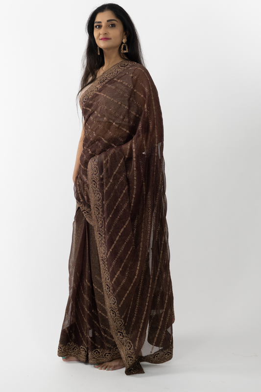 model wearing a Bronze Simar Silk Saree, highlighting the elegant drape and detailed embroidery of the luxurious Simar silk fabric.