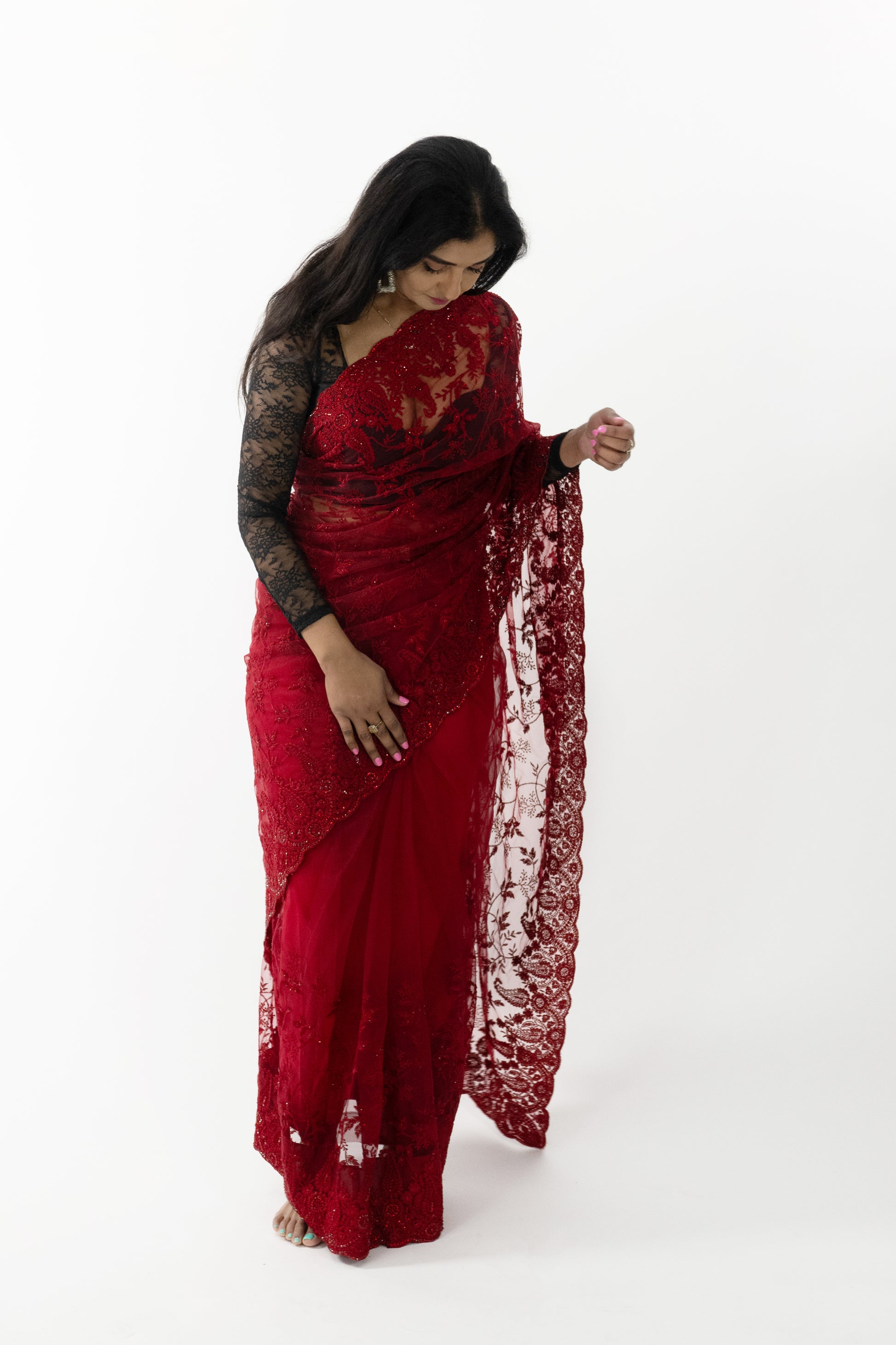Close-up of the intricate butterfly detailing on a vibrant red Butterfly Radiance Net Saree, showcasing fine craftsmanship and elegant design.