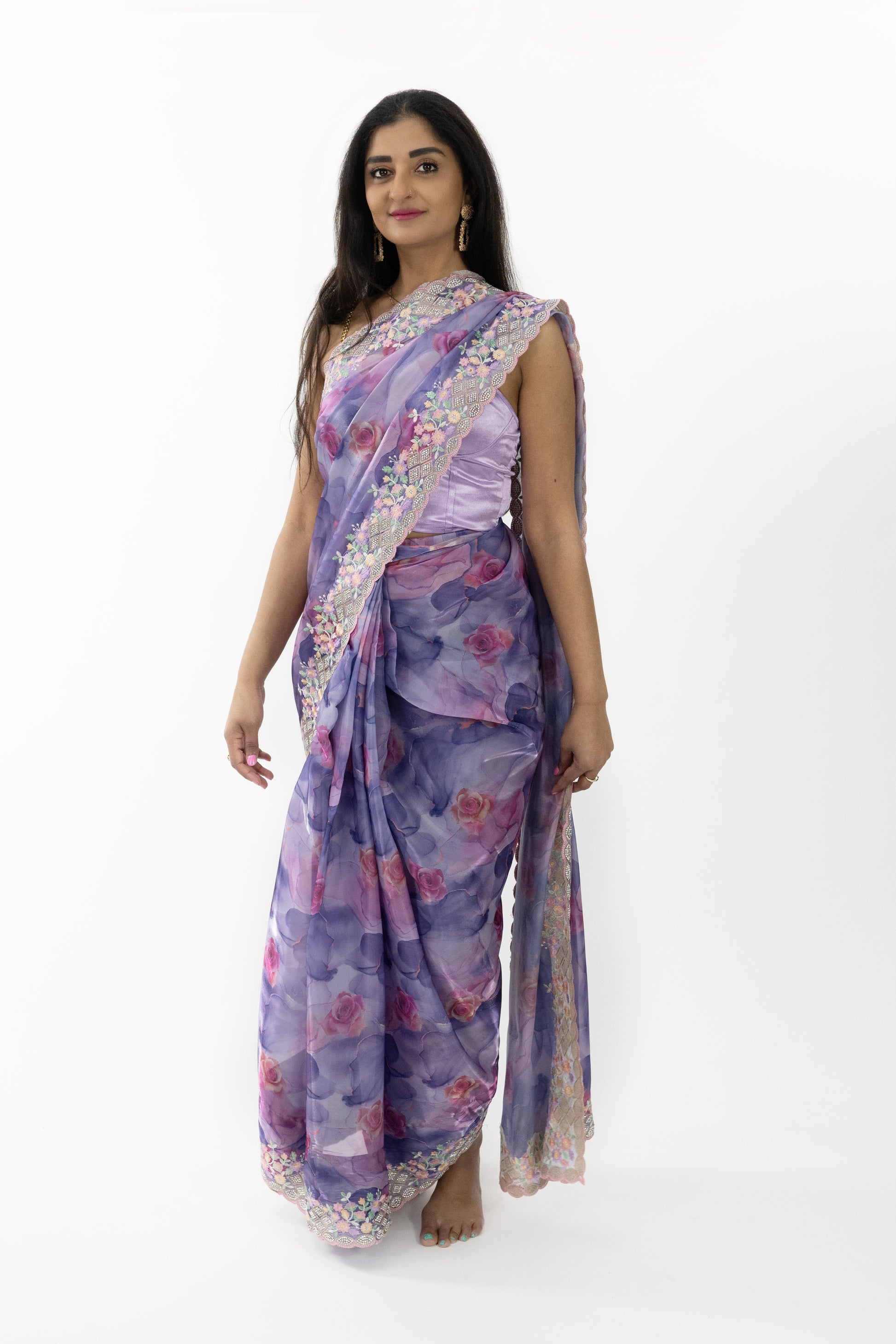 A close-up shot highlighting the exquisite floral patterns on the ready-to-wear purple silk saree in Australia. The intricate detailing showcases the artistry and attention to detail that define true luxury. The soft and smooth silk fabric drapes beautifully, making it a stunning choice for any elegant event.