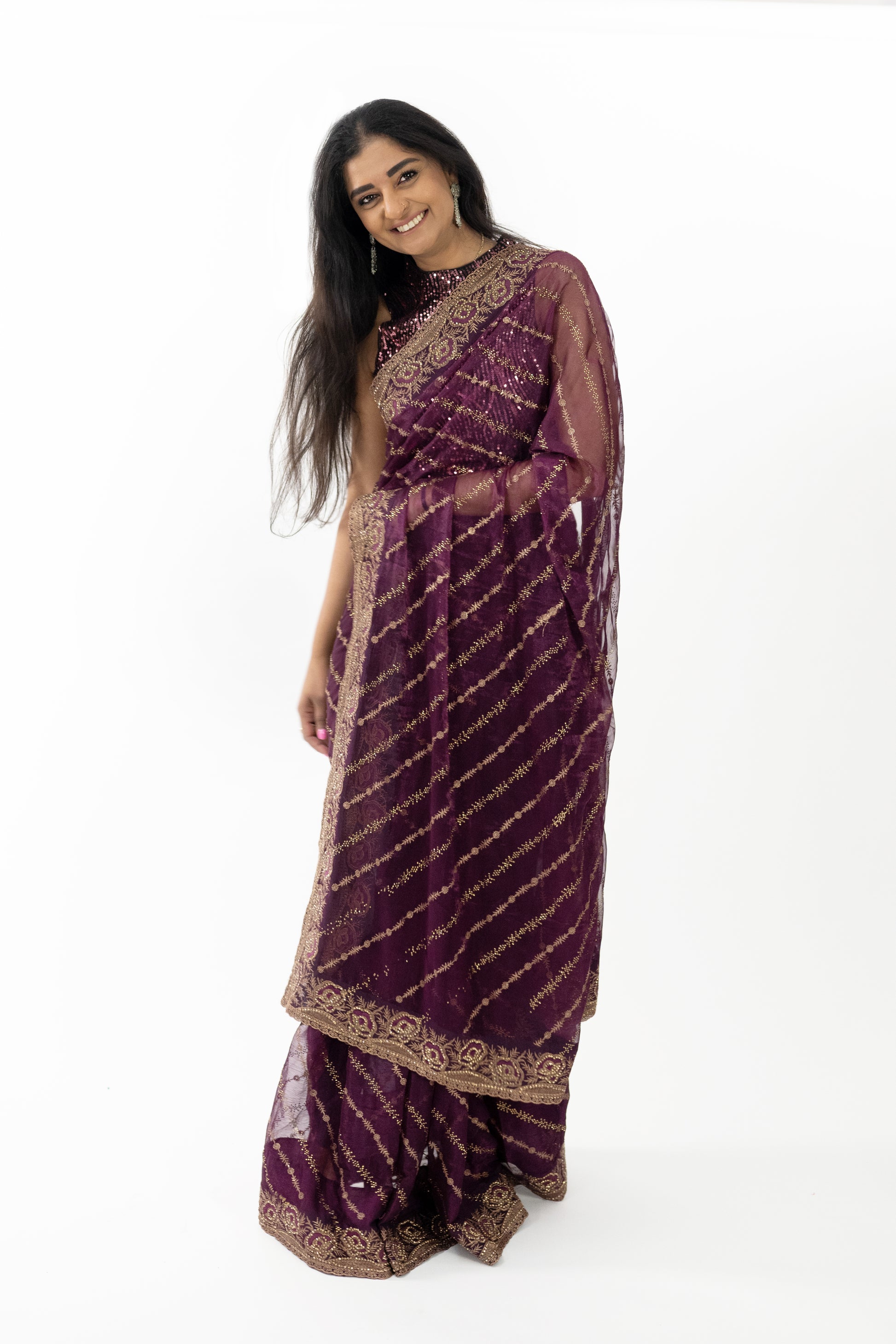 A close-up shot highlighting the exquisite gold embroidery on the ready-to-wear wine Simar silk saree in Australia. The intricate detailing showcases fine craftsmanship, adding a layer of sophistication and beauty. The luxurious Simar silk fabric drapes beautifully, making it a stunning choice for any elegant event.