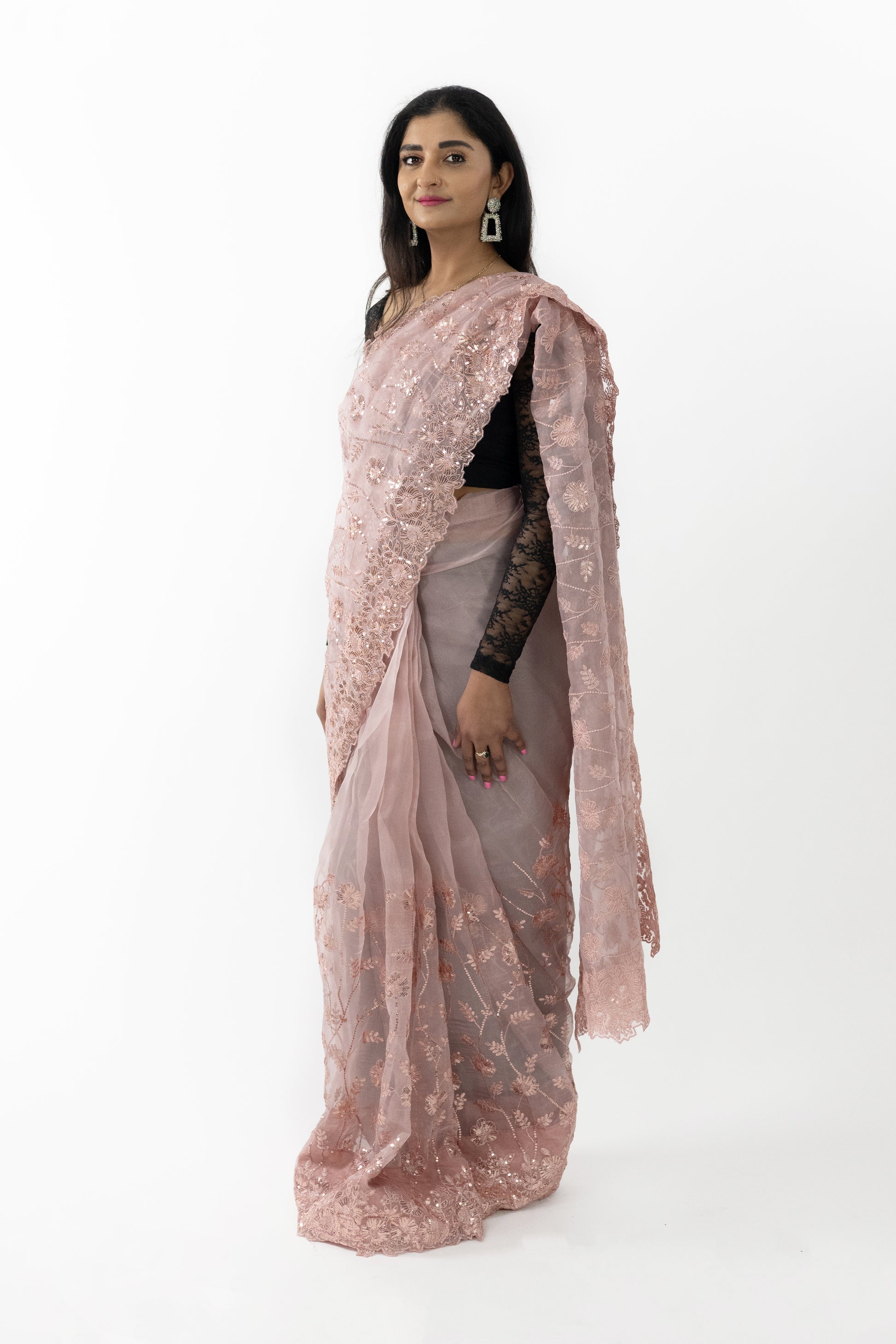 A close-up shot highlighting the intricate detailing on the ready-to-wear peach organza saree in Australia. The meticulous patterns showcase fine artistry, adding a touch of sophistication. The soft and lightweight fabric drapes beautifully, making it a stunning choice for any elegant event.