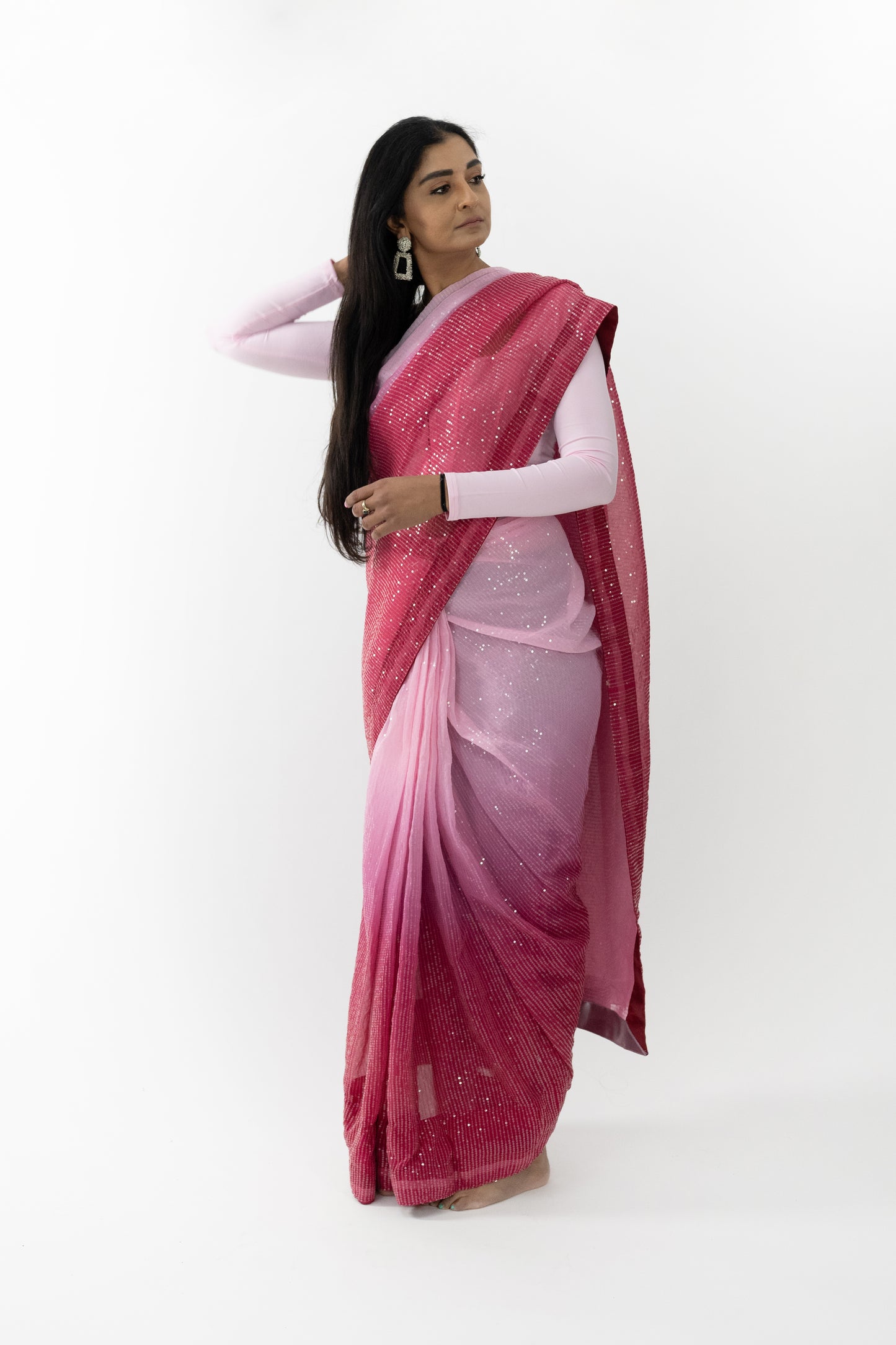 Model wearing a Crimson Splendour Faux Georgette Saree, highlighting the lightweight, fluid fabric and exquisite embroidery.