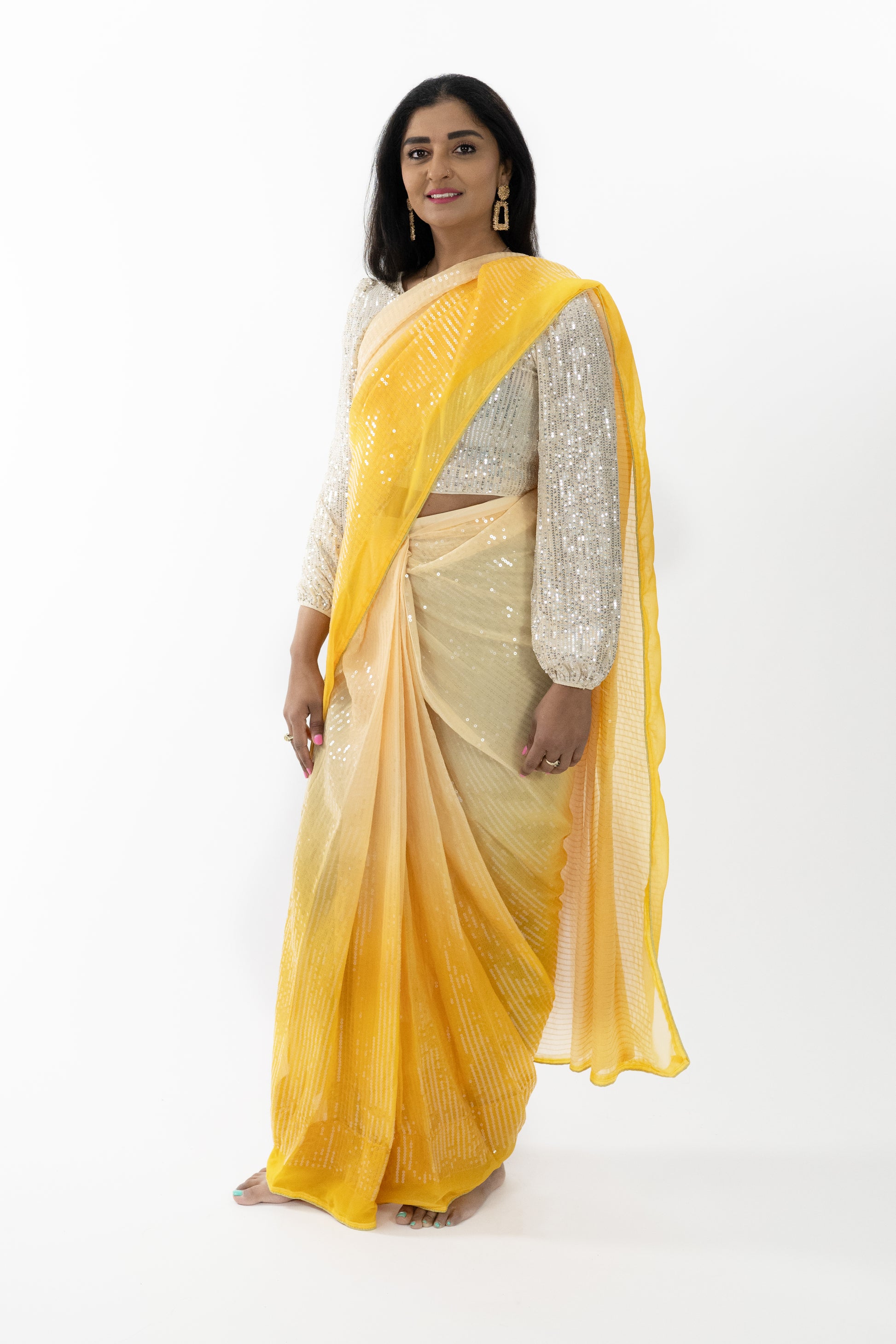 Model wearing a Golden Glow Georgette Saree, highlighting the soft, flowing fabric and exquisite craftsmanship in a captivating yellow hue