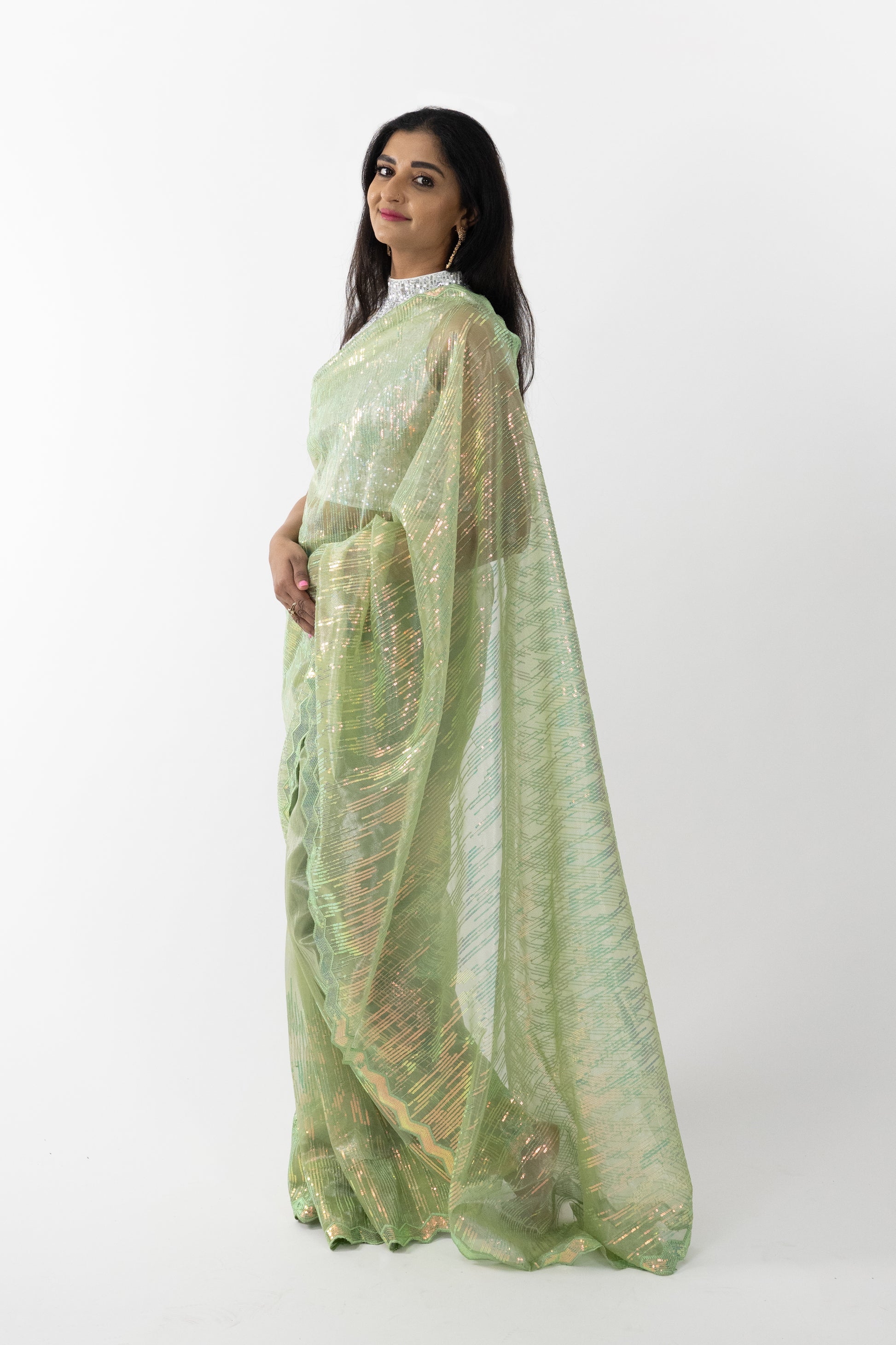 lose-up of the intricate embroidery on a Lime Aura Net Saree, showcasing fine craftsmanship and the vibrant lime colour.