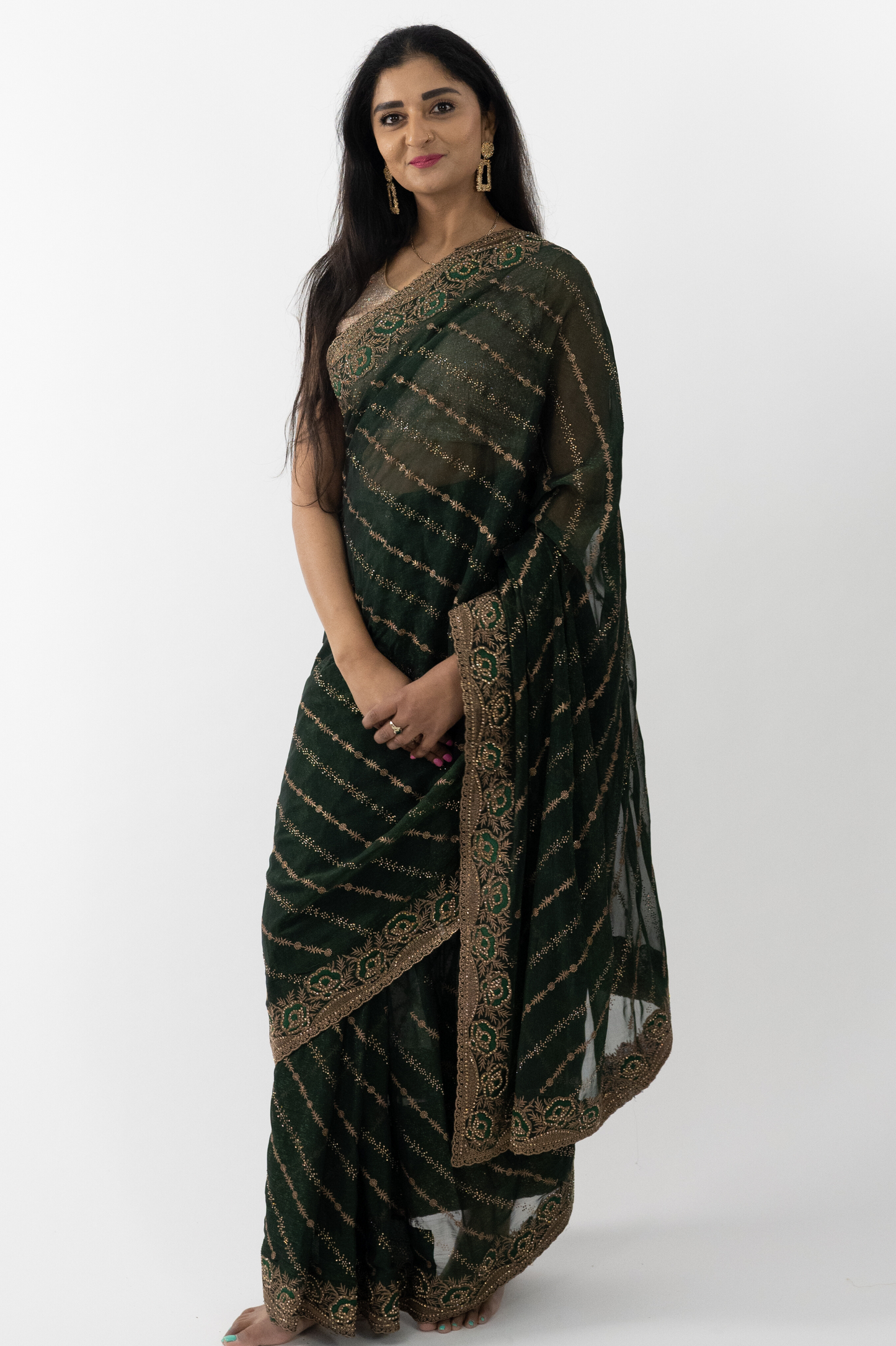 A full view of the “Royal Green Simar Silk Saree” in a rich green hue, adorned with gold embroidery. The saree’s premium Simar silk fabric is renowned for its rich texture and elegant drape, providing a comfortable and flattering fit. The deep green color exudes luxury and elegance, perfect for creating a refined look. This ready-to-wear saree is ideal for special occasions in Australia.