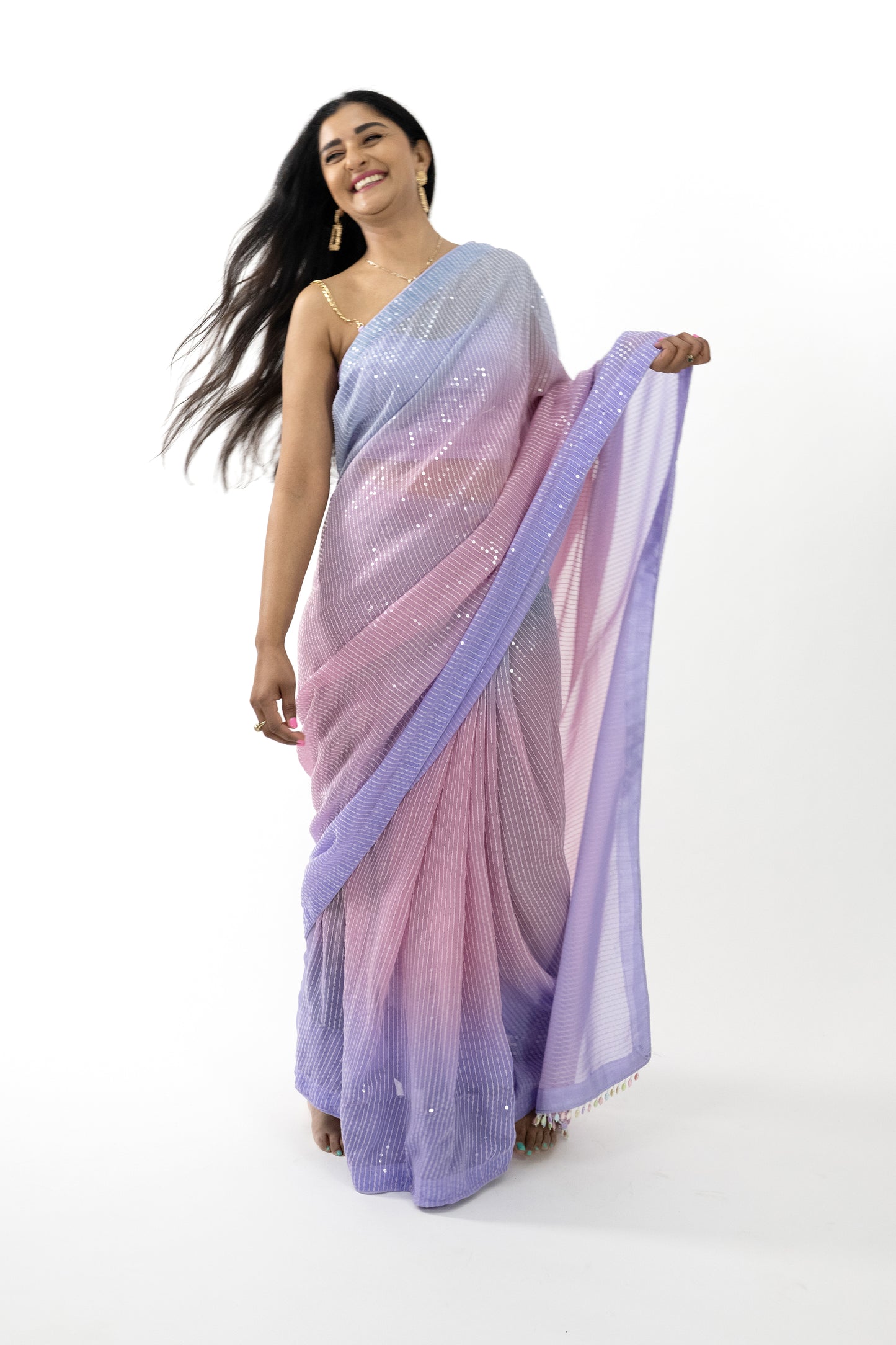 he image shows a person elegantly draped in a ready-to-wear lavender georgette saree in Australia. The saree features sequin details that add a touch of sparkle and sophistication. The light, airy georgette fabric provides a comfortable and flattering drape. This saree is perfect for special occasions, exuding elegance and grace.