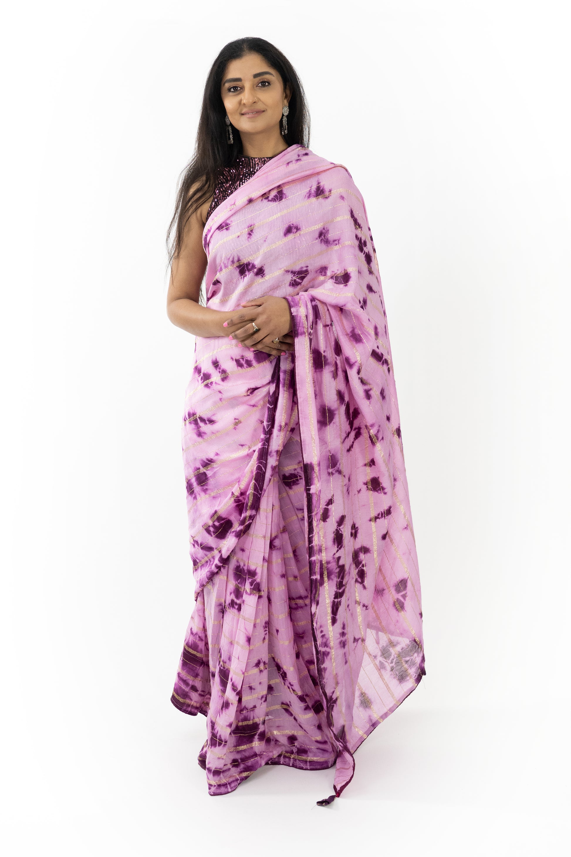 Elegant purple saree draped effortlessly, highlighting its soft, smooth fabric and meticulous craftsmanship