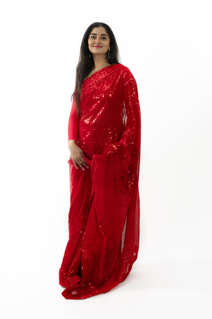  close-up shot highlighting the sparkling details on the ready-to-wear red georgette saree in Australia. The intricate patterns showcase fine artistry, adding a touch of opulence. The soft and lightweight fabric drapes beautifully, making it a stunning choice for any elegant event.