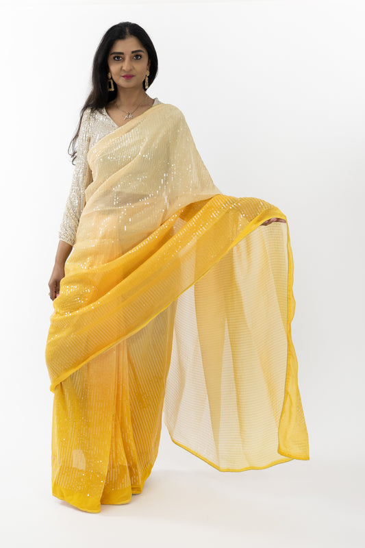 Model in a vibrant yellow Sunshine Elegance Georgette Saree, showcasing intricate patterns and a graceful drape, perfect for weddings and festive celebrations