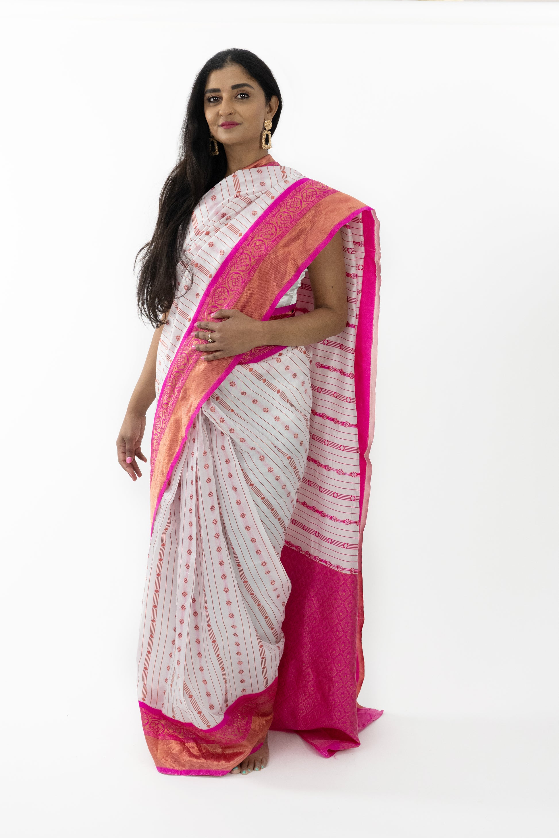 A full view of the “Pure Sophistication Banarasi Silk Saree” in a pristine white hue, adorned with pink motifs. The saree’s exquisite Banarasi soft silk fabric is renowned for its rich texture and lustrous finish, providing a comfortable and flattering fit. The pure white color symbolizes grace and purity, perfect for creating a refined look. This ready-to-wear saree is ideal for grand occasions in Australia.