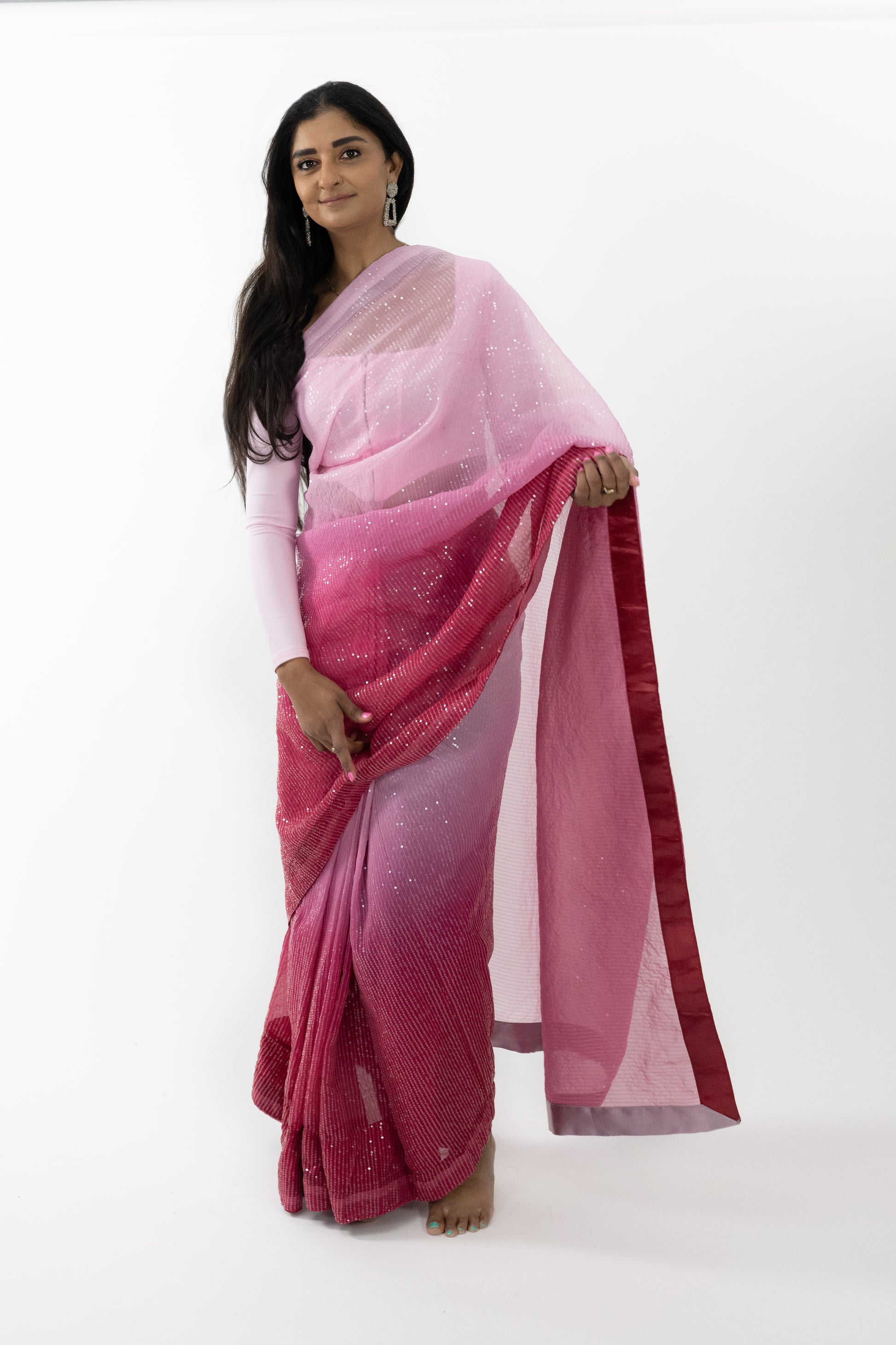 odel showcasing the front view of a vibrant red Crimson Splendour Faux Georgette Saree with intricate embroidery, perfect for special occasions