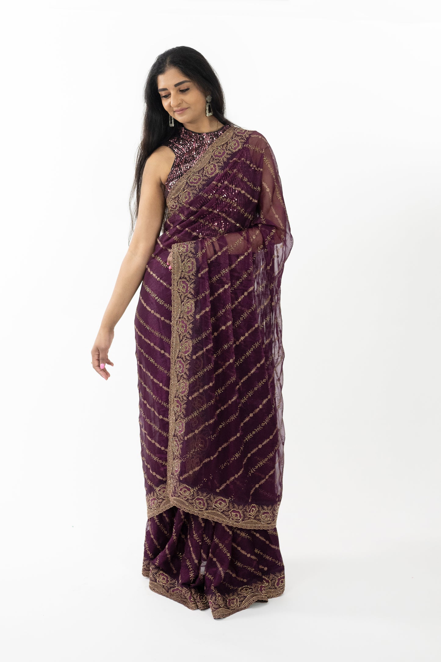 A full view of the “Royal Wine Simar Silk Saree” in a rich wine hue, adorned with gold embroidery. The saree’s premium Simar silk fabric is renowned for its rich texture and elegant drape, providing a comfortable and flattering fit. The deep wine color exudes luxury and elegance, perfect for creating a refined look. This ready-to-wear saree is ideal for special occasions in Australia.